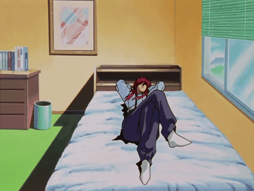 A Man With Red Hair Sits On A Bed In A Bedroom GIF
