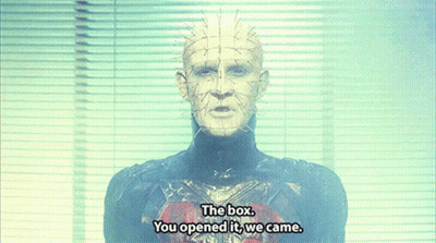 A Man With Spikes On His Head Is Standing In Front Of A Window And Says The Box You Opened It We Came GIF