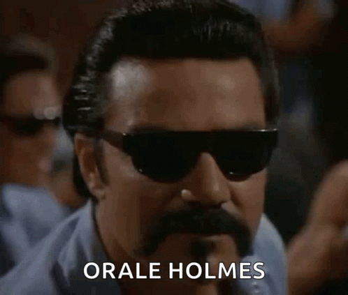 A Man With Sunglasses And A Mustache Says " Orale Holmes " GIF