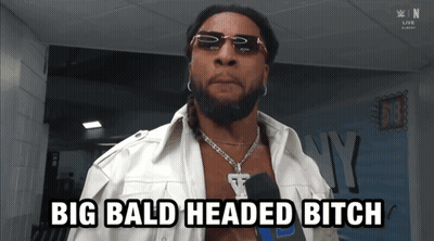 A Man With Sunglasses And A Necklace Says Big Bald Headed Bitch GIF
