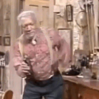 A Man With Suspenders Is Dancing In A Room . GIF