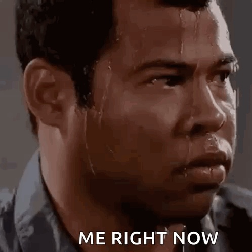 A Man With Sweat Coming Out Of His Face Is Looking At The Camera . GIF