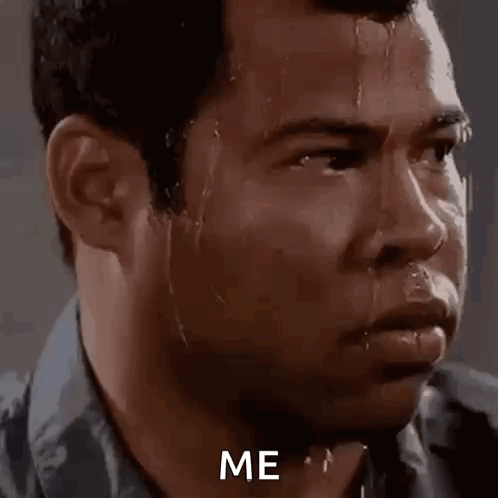 A Man With Sweat Running Down His Face Is Looking At The Camera With The Words `` Me '' Written On His Face . GIF