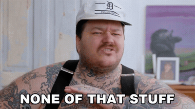 A Man With Tattoos And A Hat That Says None Of That Stuff GIF