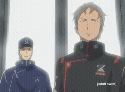 A Man With The Letter Z On His Jacket Is Standing Next To Another Man GIF