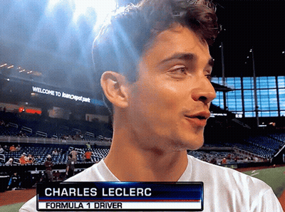 A Man With The Name Charles Leclerc On A Sign GIF