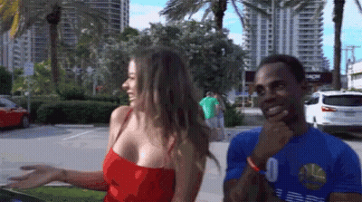 A Man With The Number 0 On His Shirt Stands Next To A Woman GIF