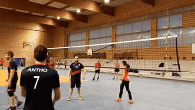 A Man With The Number 7 On His Back Stands In Front Of A Volleyball Net GIF