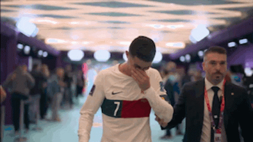 A Man With The Number 7 On His Shirt Covering His Face GIF