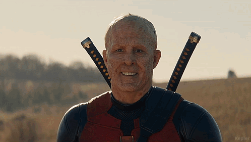 A Man With Two Swords Around His Neck Is Smiling For The Camera GIF