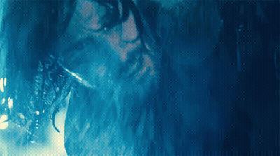 A Man With Wet Hair And A Beard Looks At The Camera GIF