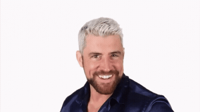 A Man With White Hair And A Beard Wearing A Blue Shirt GIF