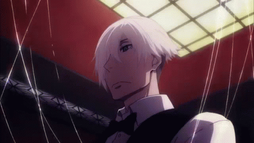 A Man With White Hair And A Bow Tie Is Holding A String Around His Neck . GIF