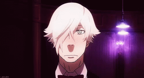 A Man With White Hair And A Bow Tie Is Standing In A Dark Room GIF