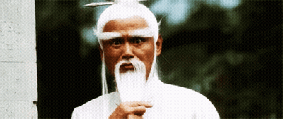 A Man With White Hair And A White Beard Holds A Sword GIF