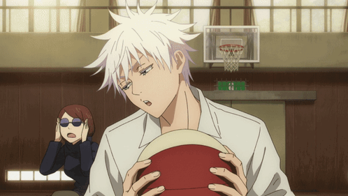 A Man With White Hair Holds A Red Basketball In His Hands GIF