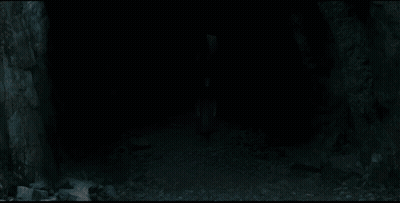 A Man With White Hair Is Holding A Knife In His Hand GIF