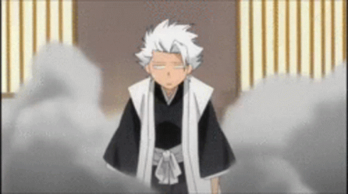 A Man With White Hair Is Standing In A Room With A Striped Wall . GIF