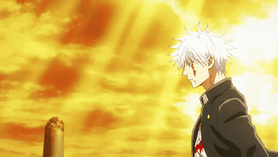 A Man With White Hair Is Standing In Front Of An Orange Sky GIF
