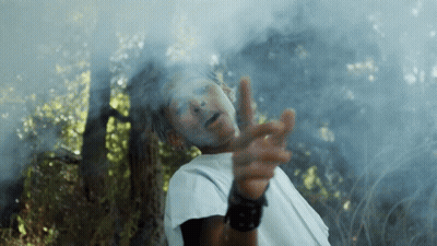 A Man With White Paint On His Face Is Pointing At The Camera GIF