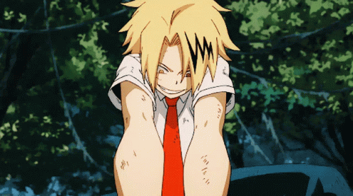 A Man With Yellow Hair And A Red Tie Is Sitting Down GIF