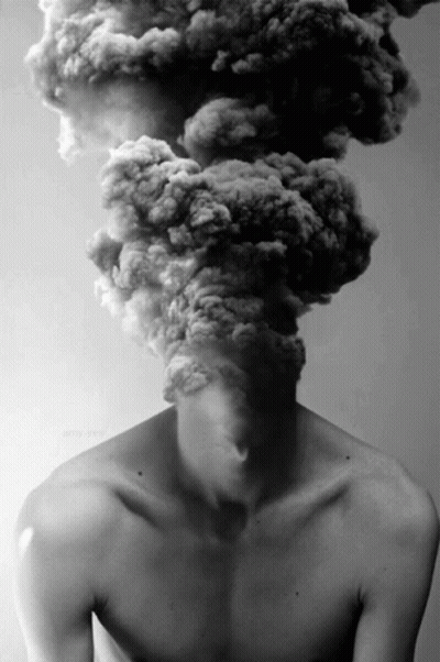 A Man Without A Shirt Has Smoke Coming Out Of His Head .. GIF