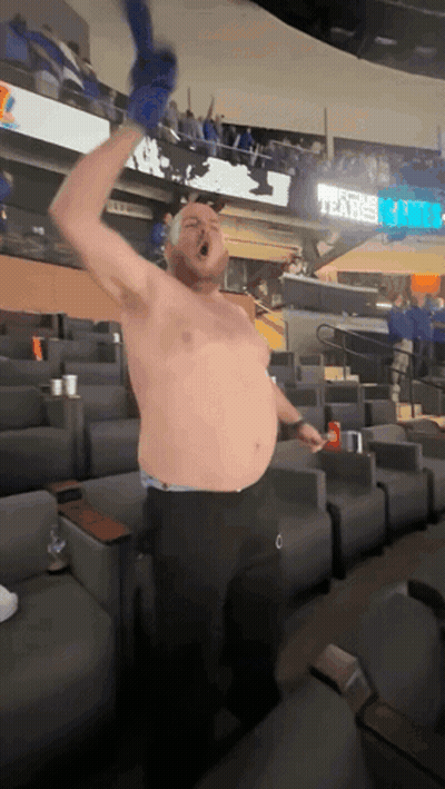 A Man Without A Shirt In A Stadium With A Sign That Says Tears On It GIF
