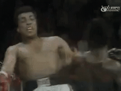 A Man Without A Shirt Is Boxing In A Ring . GIF
