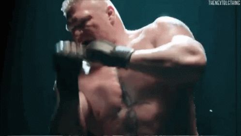 A Man Without A Shirt Is Fighting Another Man In A Boxing Ring . GIF