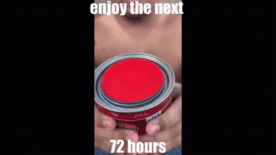 A Man Without A Shirt Is Holding A Black Container With A Red Liquid Coming Out Of It . GIF