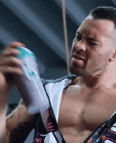 A Man Without A Shirt Is Holding A Bottle Of Lotion GIF