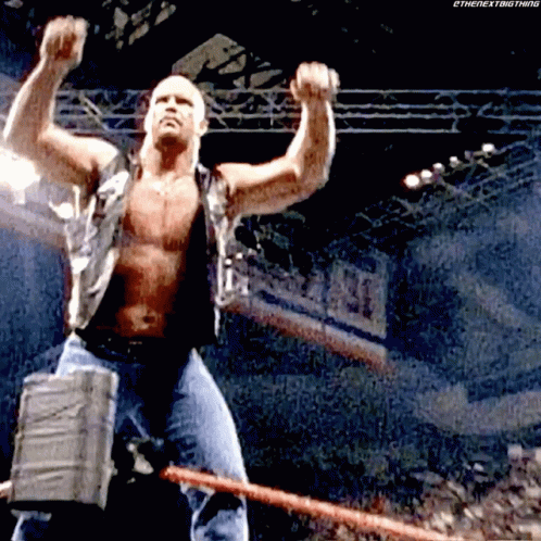 A Man Without A Shirt Is Holding A Large Hammer In His Hand . GIF