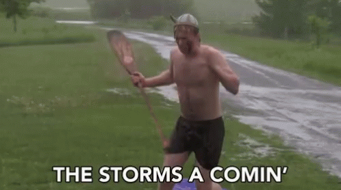 A Man Without A Shirt Is Holding A Paddle In The Rain . GIF