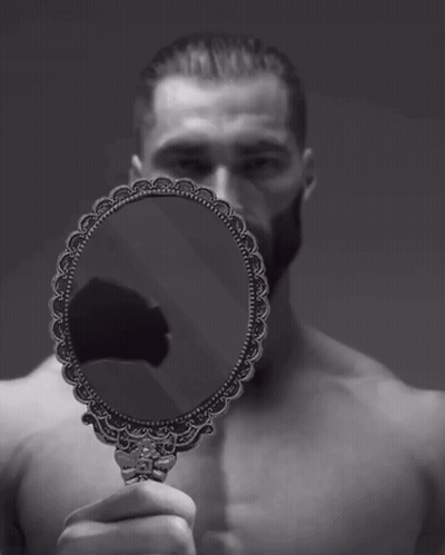 A Man Without A Shirt Is Holding A Small Mirror In Front Of His Face GIF