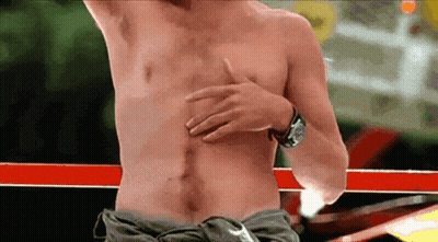 A Man Without A Shirt Is Holding His Chest With His Hand GIF