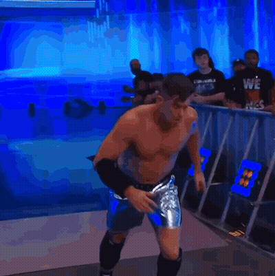 A Man Without A Shirt Is Jumping In The Air In Front Of A Blue Background GIF