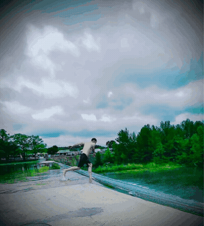 A Man Without A Shirt Is Jumping Into The Water GIF