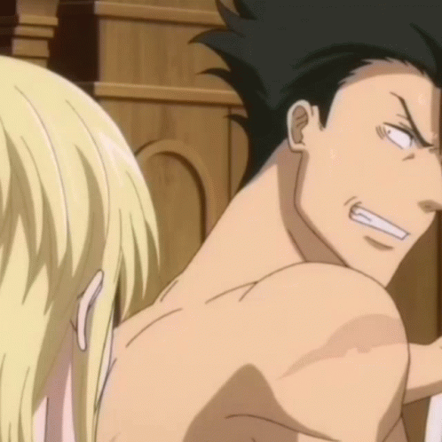 A Man Without A Shirt Is Looking At A Blonde Woman GIF