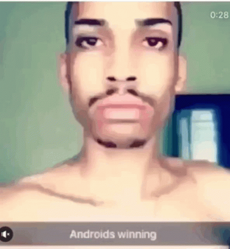 A Man Without A Shirt Is Looking At The Camera With The Words Androids Winning Below Him GIF
