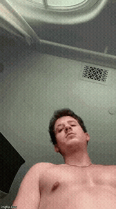 A Man Without A Shirt Is Looking Up At The Ceiling GIF