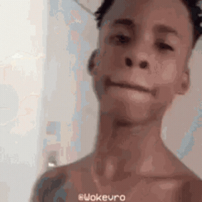 A Man Without A Shirt Is Making A Funny Face In A Blurry Photo . GIF