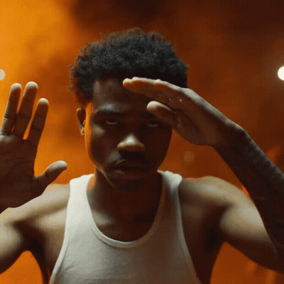 A Man Without A Shirt Is Making A Gesture With His Hands GIF