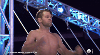 A Man Without A Shirt Is On A Nbc Show Called American Ninja Warrior GIF