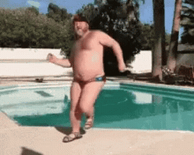 A Man Without A Shirt Is Running By A Pool GIF