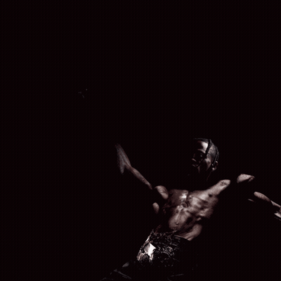 A Man Without A Shirt Is Screaming With His Arms Outstretched GIF