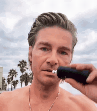 A Man Without A Shirt Is Shaving His Nose With A Razor . GIF