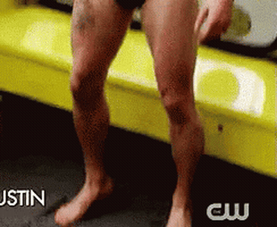A Man Without A Shirt Is Sitting On A Yellow Couch With The Words Justin Behind Him GIF