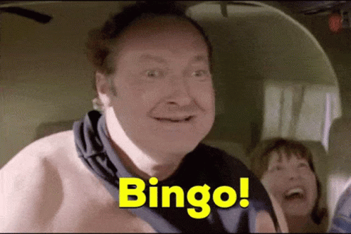 A Man Without A Shirt Is Smiling And Says Bingo GIF
