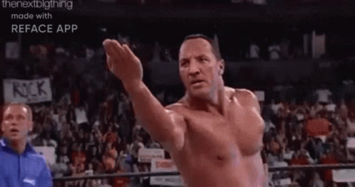 A Man Without A Shirt Is Standing In A Boxing Ring With His Arm Outstretched . GIF