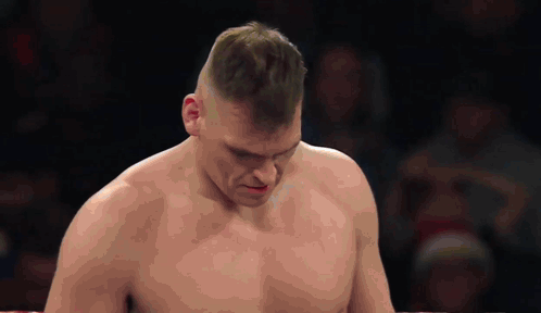 A Man Without A Shirt Is Standing In A Boxing Ring With His Eyes Closed GIF